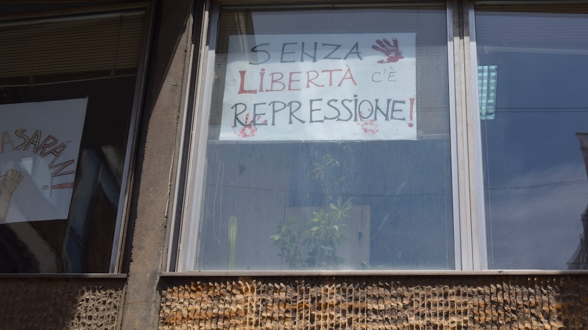 Window displays a sign about freedom and repression.